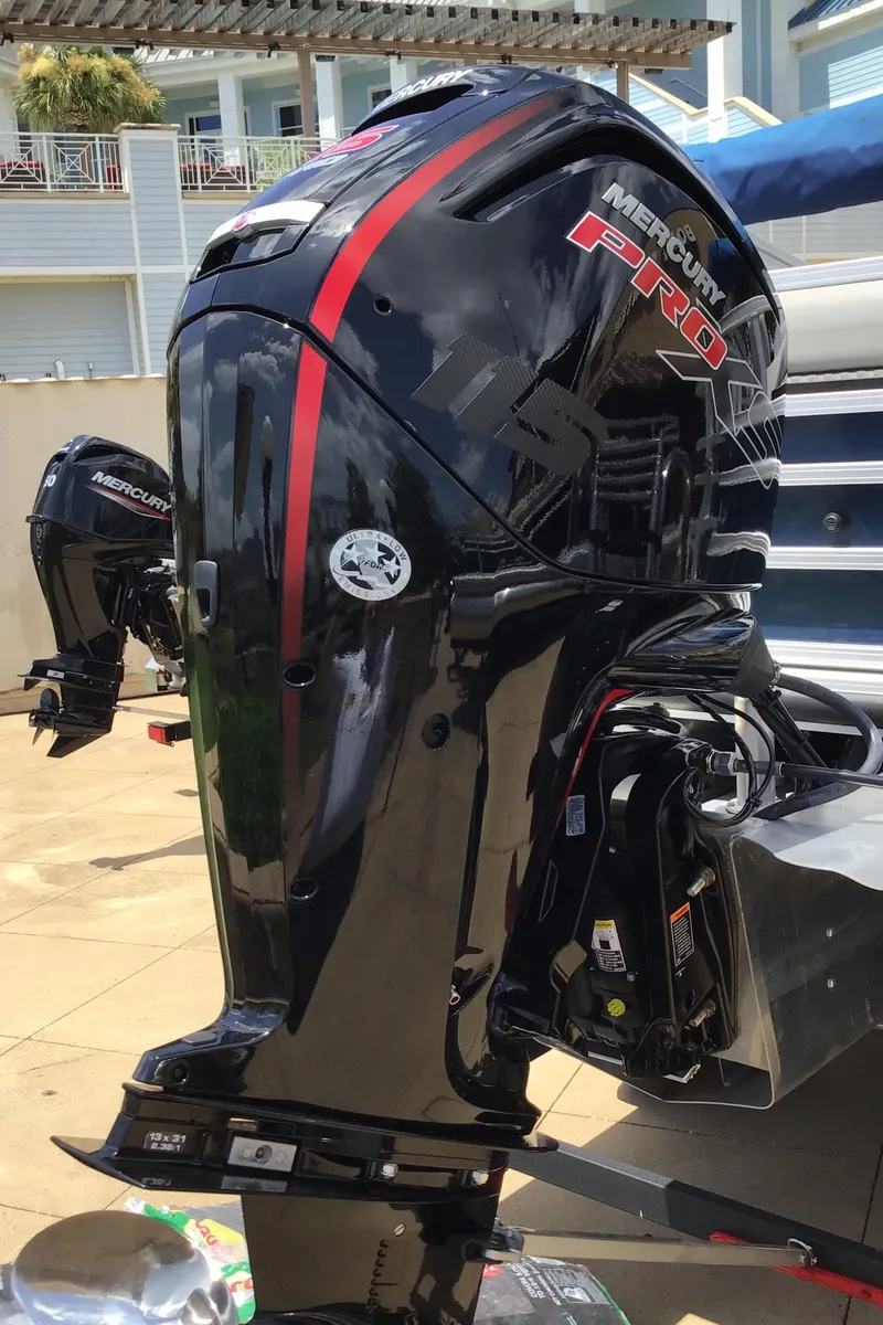Slide: The Image of 2024 Ranger Reata 220F with Mercury Pro outboard motor, docked outdoors. - 3
