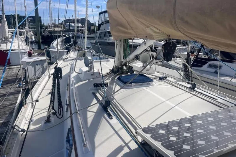 Slide: The Image of 2002 Pacific Seacraft 40 sailboat docked, featuring solar panels and rigging. - 15