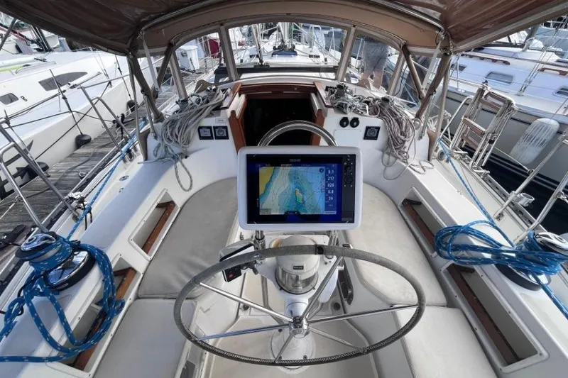 Slide: The Image of Cockpit of 2002 Pacific Seacraft 40 sailboat with navigation equipment and steering wheel. - 18