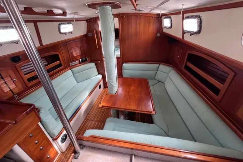 Slide: The Image of Interior of 2002 Pacific Seacraft 40 sailboat with wooden furnishings and cushioned seating. - 28
