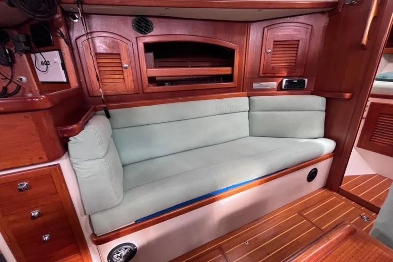 Slide: The Image of Cozy interior of 2002 Pacific Seacraft 40 sailboat with wooden cabinetry and cushioned seating. - 29