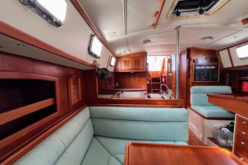 Slide: The Image of Interior of 2002 Pacific Seacraft 40 sailboat with wood finish and light blue seating. - 31