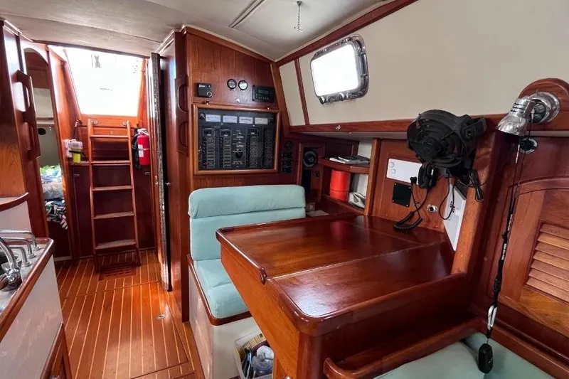 Slide: The Image of Interior of 2002 Pacific Seacraft 40 sailboat with wooden cabinetry and navigation station. - 32