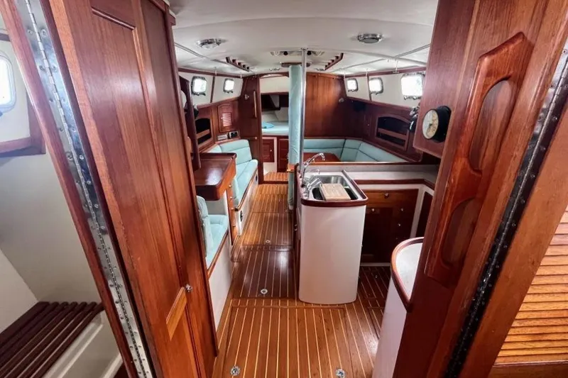 Slide: The Image of Interior of 2002 Pacific Seacraft 40 yacht with wooden finishes and compact kitchen area. - 33