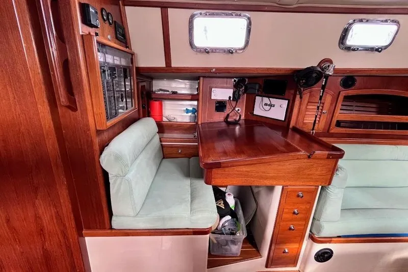 Slide: The Image of Interior of 2002 Pacific Seacraft 40 sailboat with navigation station and wooden cabinetry. - 34