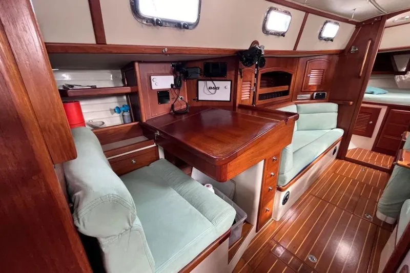 Slide: The Image of Interior of 2002 Pacific Seacraft 40 sailboat with wooden furnishings and cozy seating. - 35