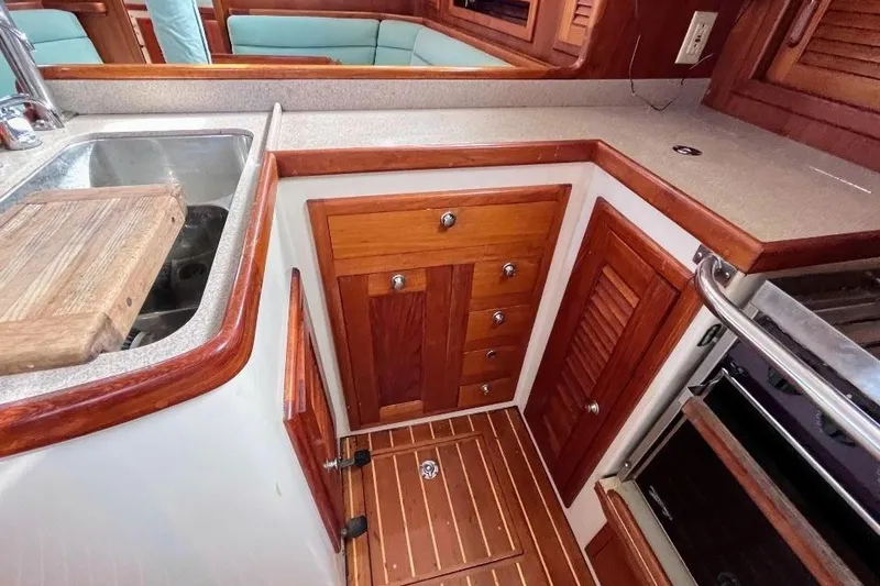 Slide: The Image of Interior of 2002 Pacific Seacraft 40 yacht kitchen with wooden cabinetry and stainless steel sink. - 39