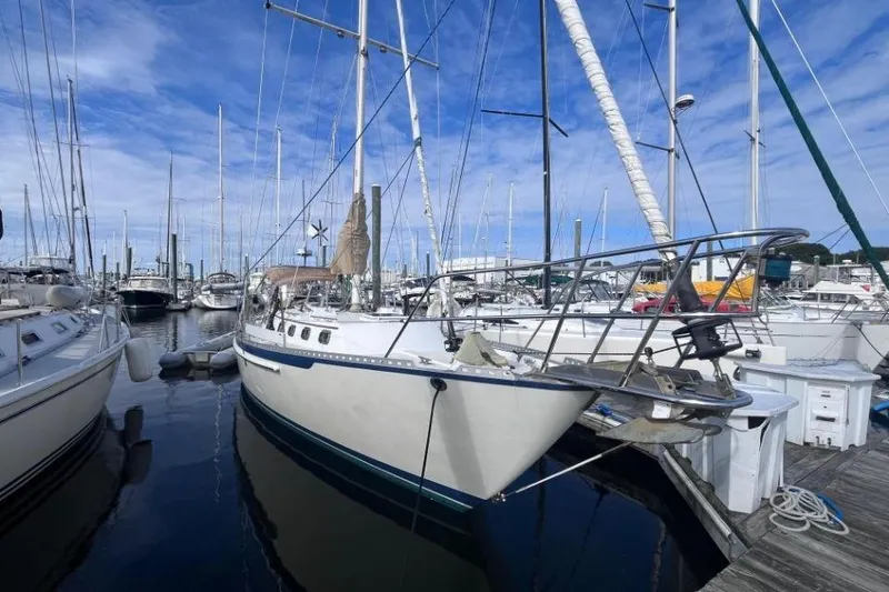 Slide: The Image of 2002 Pacific Seacraft 40 sailboat docked in a marina under a clear blue sky. - 4