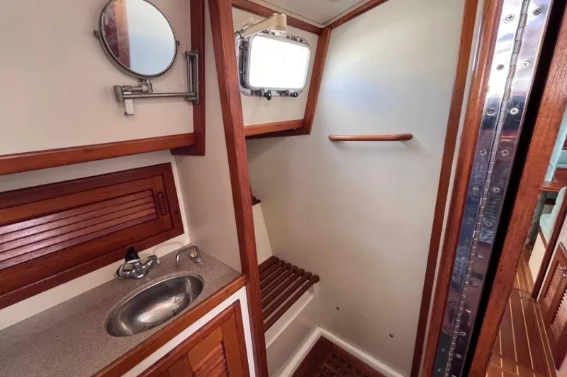 Slide: The Image of Interior of 2002 Pacific Seacraft 40 yacht bathroom with sink and shower area. - 42