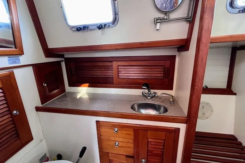 Slide: The Image of Interior of 2002 Pacific Seacraft 40 sailboat with wooden cabinetry and compact sink. - 43