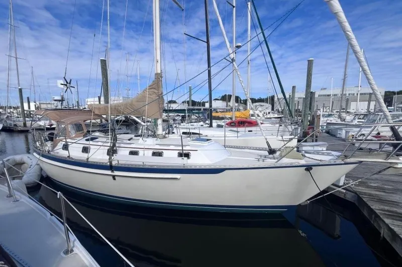 Slide: The Image of 2002 Pacific Seacraft 40 sailboat docked in a marina under a blue sky. - 5