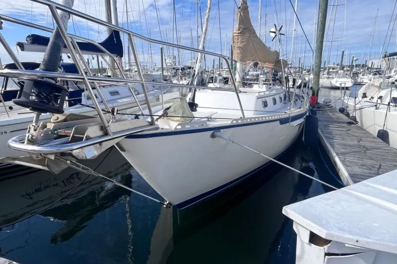 Slide: The Image of 2002 Pacific Seacraft 40 sailboat docked in a marina, surrounded by other boats. - 7