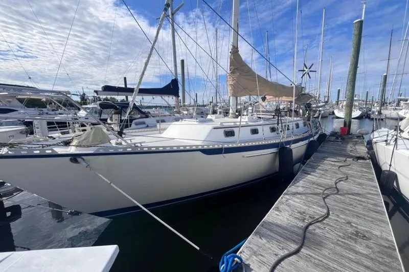 Slide: The Image of 2002 Pacific Seacraft 40 sailboat docked at marina under blue sky. - 8