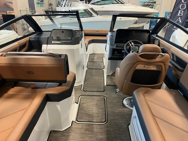 Slide: The Image of 2025 Cobalt R6 boat interior with luxurious brown seating and modern dashboard. - 10