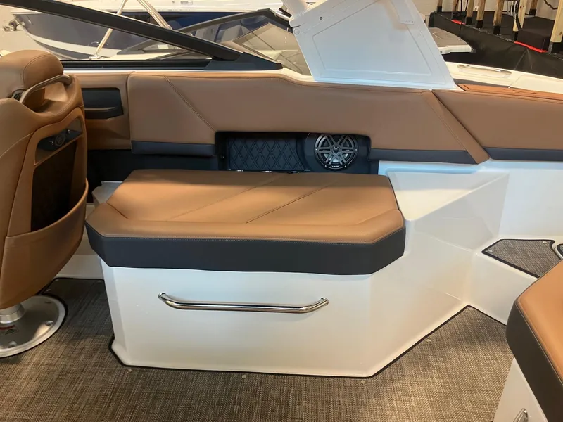 Slide: The Image of 2025 Cobalt R6 boat interior with brown leather seating and modern design elements. - 11