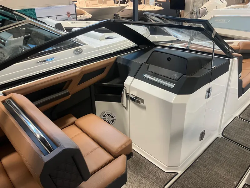 Slide: The Image of 2025 Cobalt R6 boat interior with tan seating and sleek dashboard design. - 13
