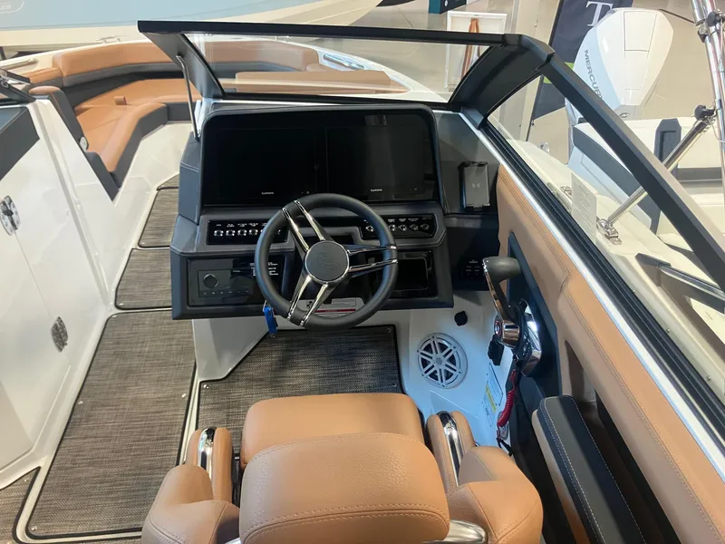 Slide: The Image of 2025 Cobalt R6 boat interior with modern dashboard and leather seating. - 15