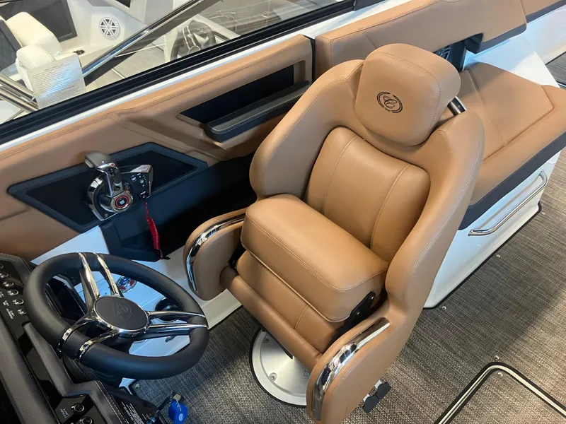 Slide: The Image of Luxurious interior of 2025 Cobalt R6 boat with tan leather captain's chair and modern controls. - 17