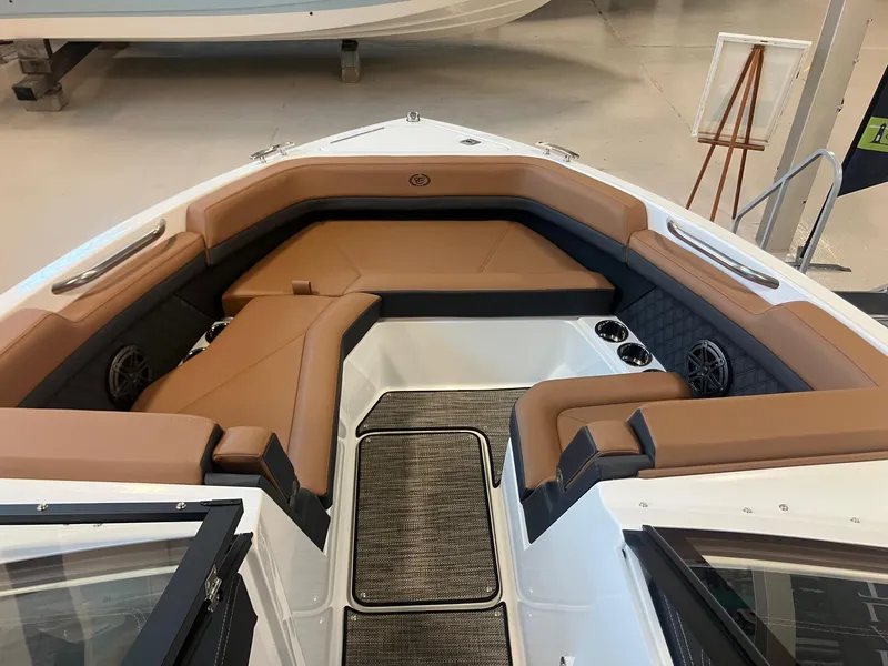 Slide: The Image of 2025 Cobalt R6 boat interior with tan seating, cup holders, and speakers. - 18