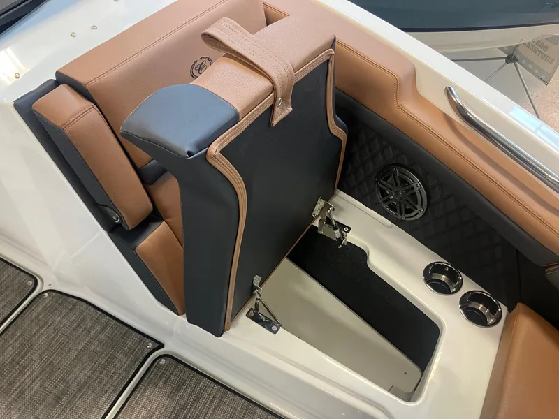 Slide: The Image of 2025 Cobalt R6 boat interior with tan seating, storage compartment, and cup holders. - 20