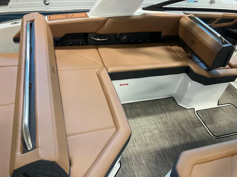 Slide: The Image of 2025 Cobalt R6 boat interior with tan leather seating and stainless steel accents. - 6