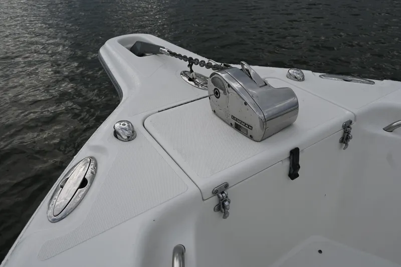 Slide: The Image of Bow of 2002 Triton 2895 CC boat with anchor winch on calm water. - 14