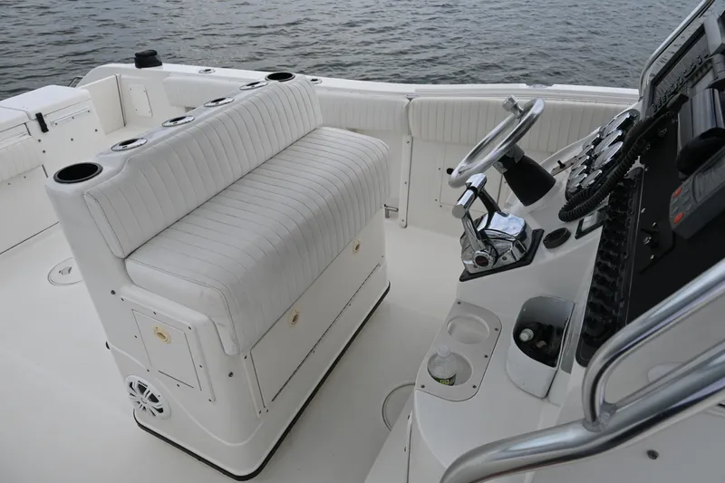 Slide: The Image of 2002 Triton 2895 CC boat interior with white seating and control panel. - 20