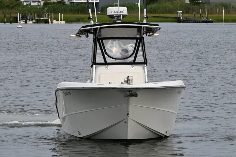 Slide: The Image of 2002 Triton 2895 CC boat cruising on a calm river. - 3