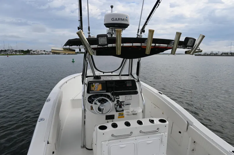 Slide: The Image of 2002 Triton 2895 CC boat with Garmin equipment on calm water. - 31