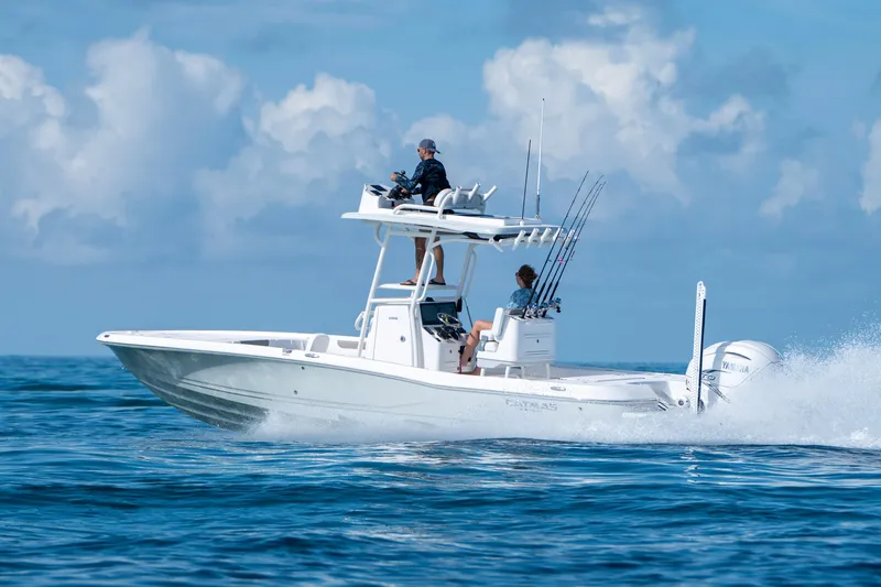 The Image of 2024 Caymas 28 HB boat cruising on open water under a clear blue sky. - 1