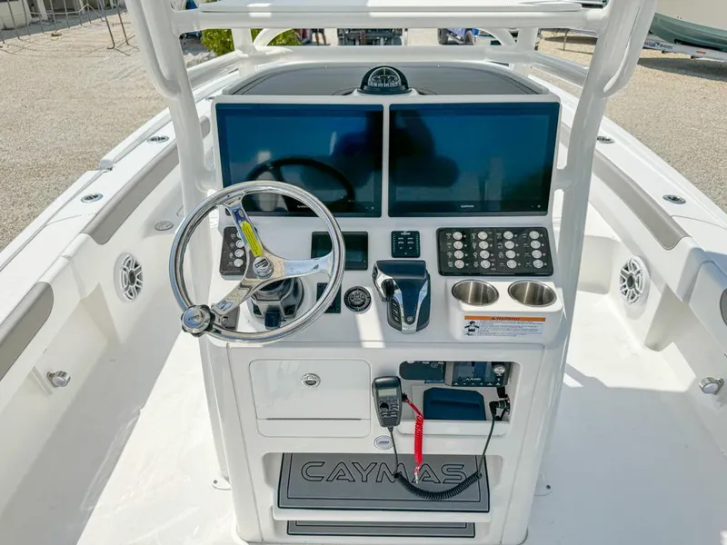 Slide: The Image of 2024 Caymas 28 HB boat dashboard with dual screens and steering wheel. - 13
