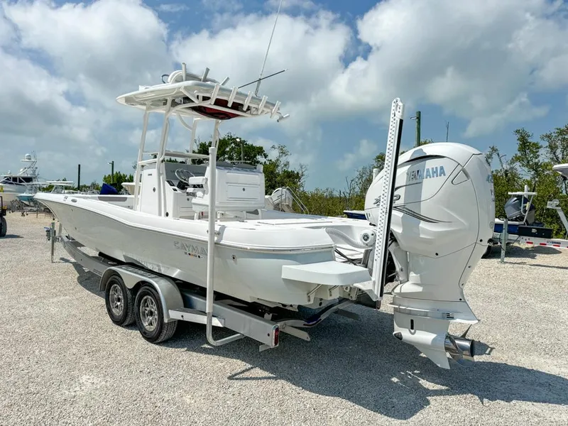 Slide: The Image of 2024 Caymas 28 HB boat on trailer with Yamaha outboard motor, parked outdoors. - 5