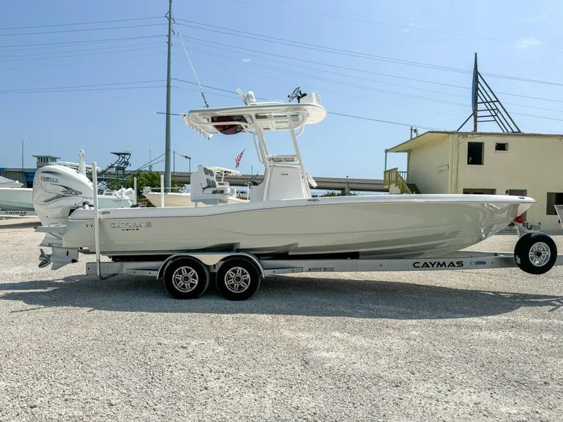 Slide: The Image of 2024 Caymas 28 HB boat on trailer, side view, outdoors, clear sky. - 8