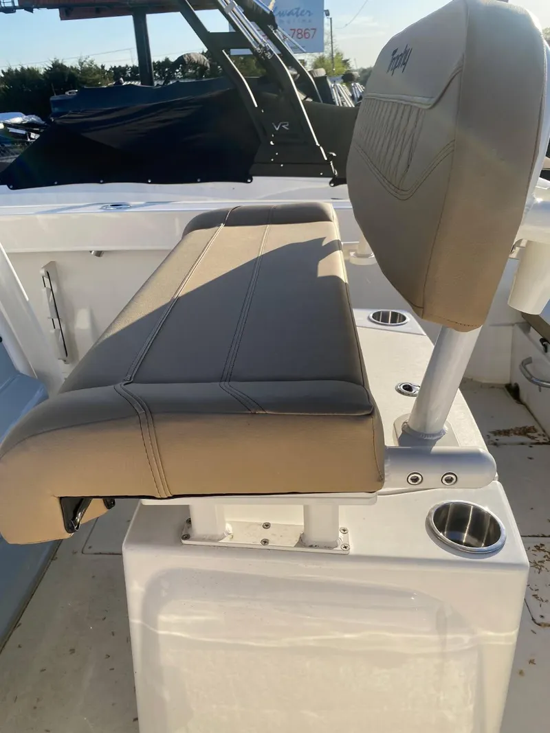 Slide: The Image of 2025 Bayliner Trophy T22CC boat seat with cup holders and beige upholstery. - 10