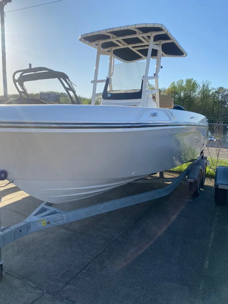 Slide: The Image of 2025 Bayliner Trophy T22CC boat on trailer, side view, sunny day. - 2