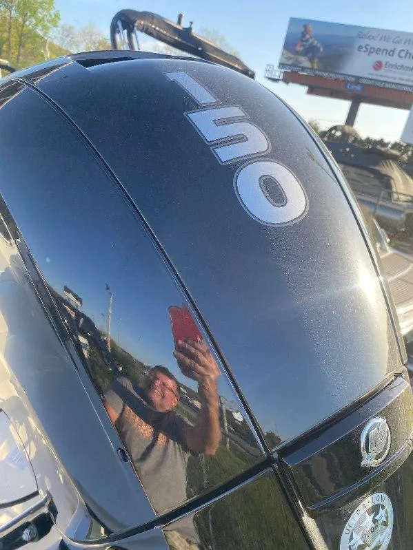 Slide: The Image of Close-up of a 150 HP engine on a 2025 Bayliner Trophy T22CC boat. - 4