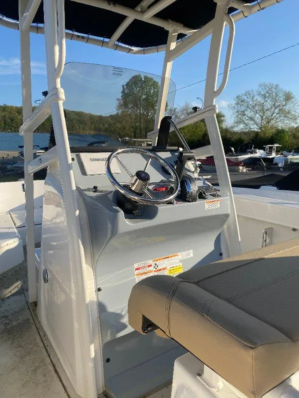 Slide: The Image of 2025 Bayliner Trophy T22CC boat console with steering wheel and seating. - 6