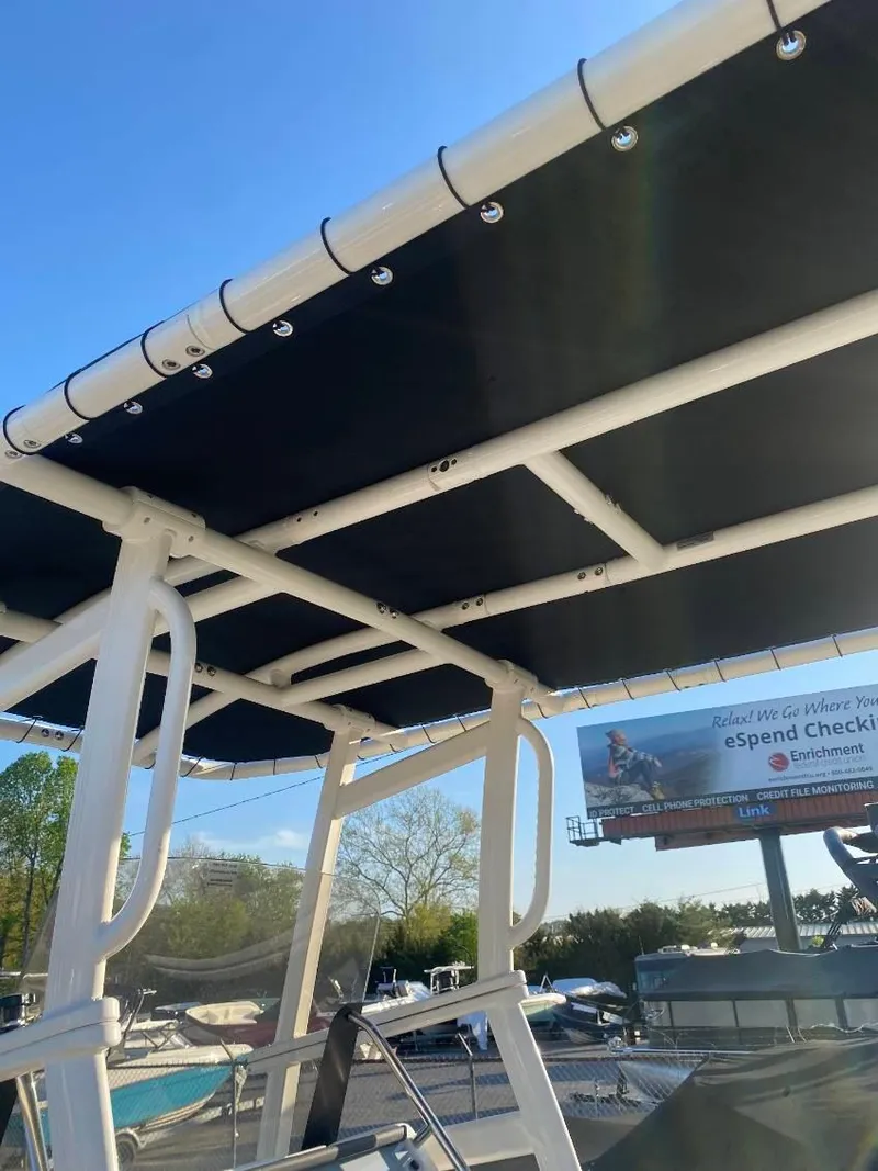 Slide: The Image of 2025 Bayliner Trophy T22CC boat with a sturdy T-top under clear blue sky. - 9