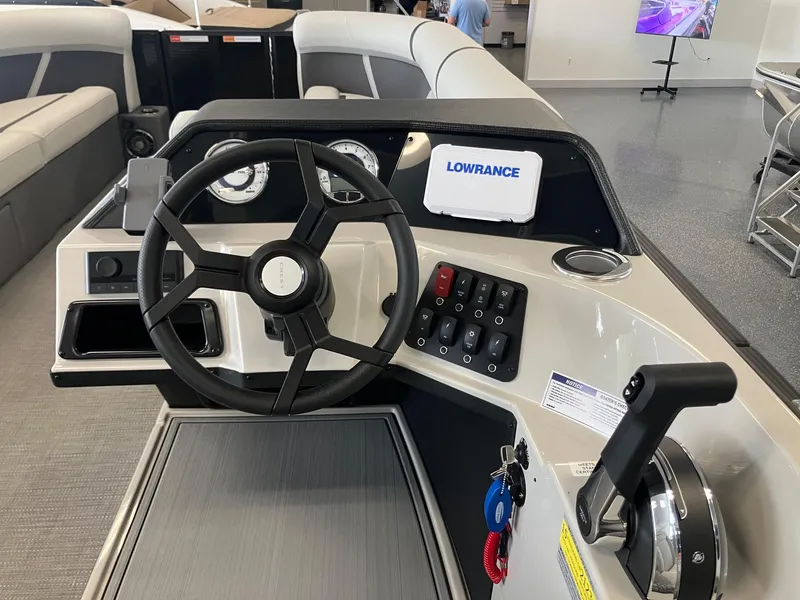 Slide: The Image of 2025 Crest 240 SLC Classic LX boat dashboard with steering wheel and controls. - 10