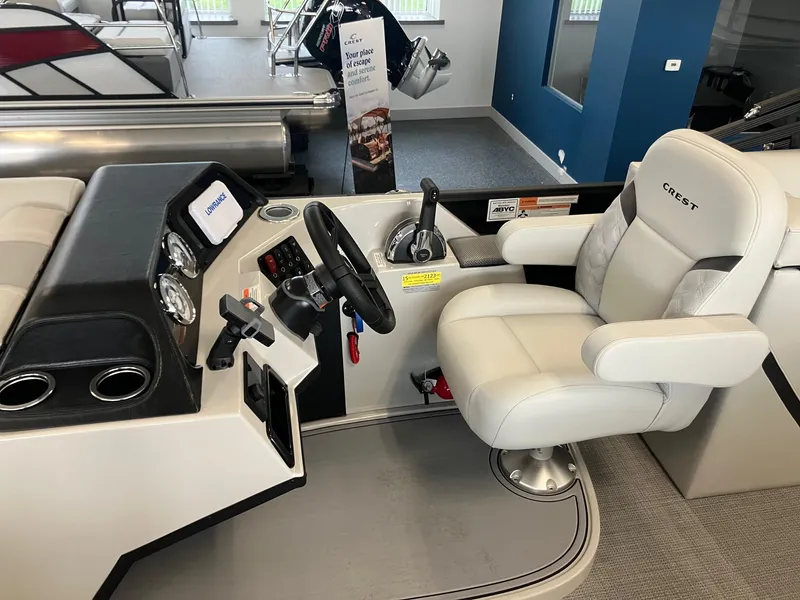 Slide: The Image of 2025 Crest 240 SLC Classic LX boat helm with luxurious captain's chair and modern controls. - 11