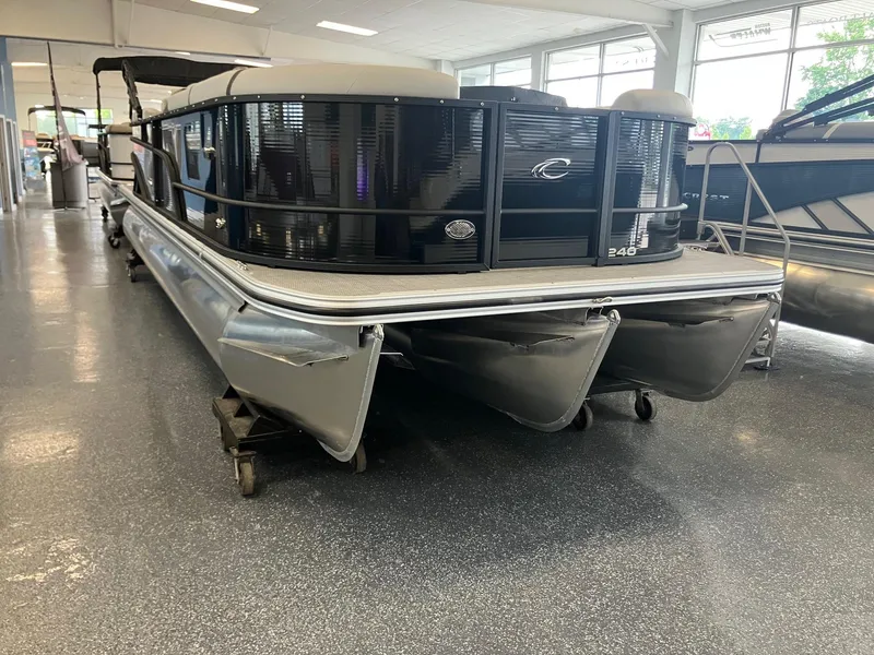 Slide: The Image of 2025 Crest 240 SLC Classic LX pontoon boat displayed indoors. - 2