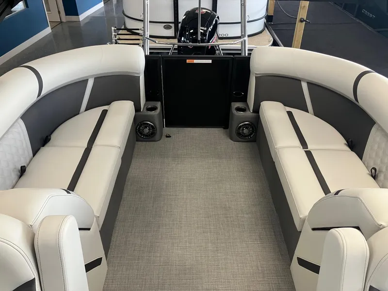 Slide: The Image of Interior of 2025 Crest 240 SLC Classic LX pontoon boat with stylish seating and speakers. - 5