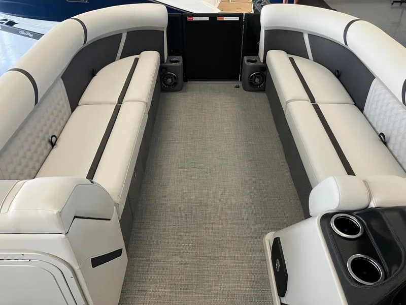 Slide: The Image of 2025 Crest 240 SLC Classic LX boat interior with luxurious seating and cup holders. - 7