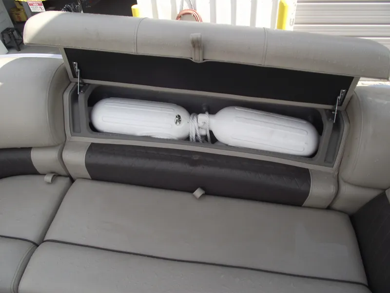 Slide: The Image of 2023 Sun Tracker Party Barge 20 DLX storage compartment with white fenders inside. - 13