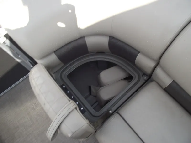 Slide: The Image of 2023 Sun Tracker Party Barge 20 DLX storage compartment with cushioned seating. - 15