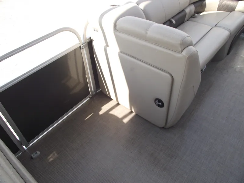 Slide: The Image of 2023 Sun Tracker Party Barge 20 DLX interior with beige seating and flooring. - 18