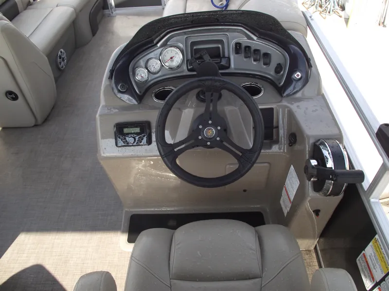 Slide: The Image of 2023 Sun Tracker Party Barge 20 DLX helm with steering wheel and controls. - 21