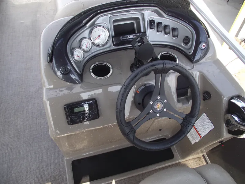 Slide: The Image of Steering console of 2023 Sun Tracker Party Barge 20 DLX with gauges and controls. - 22