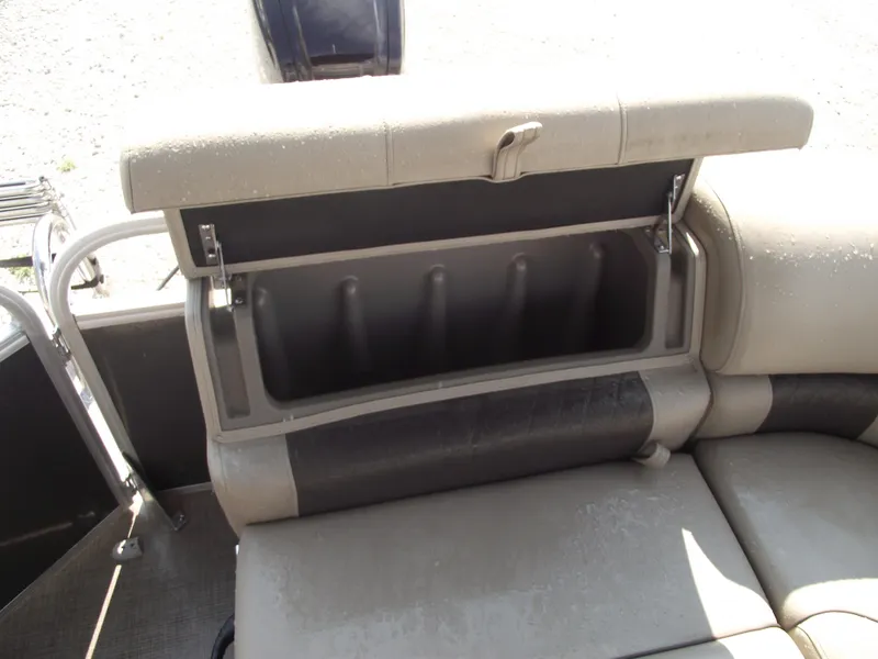 Slide: The Image of 2023 Sun Tracker Party Barge 20 DLX storage compartment with open seat cushion. - 25