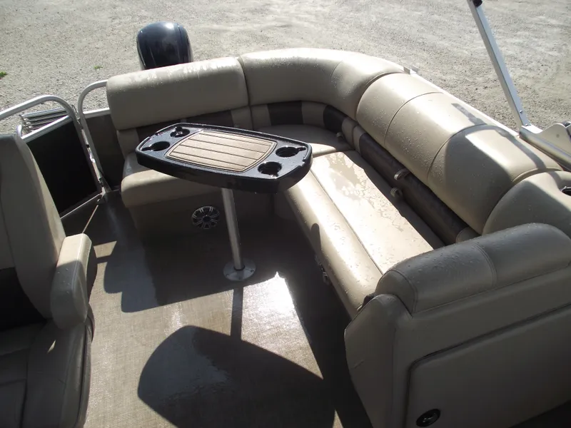 Slide: The Image of 2023 Sun Tracker Party Barge 20 DLX interior with beige seating and a central table. - 35